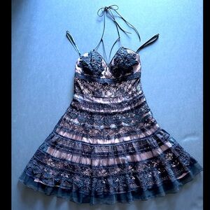 Elegant crochet dress with leather straps, stunning and feminine.